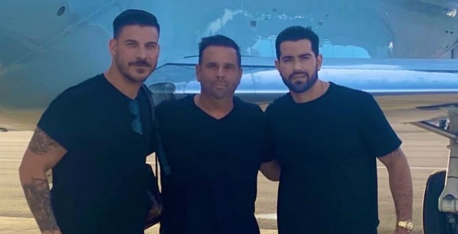 Three man stand in front of a private plane