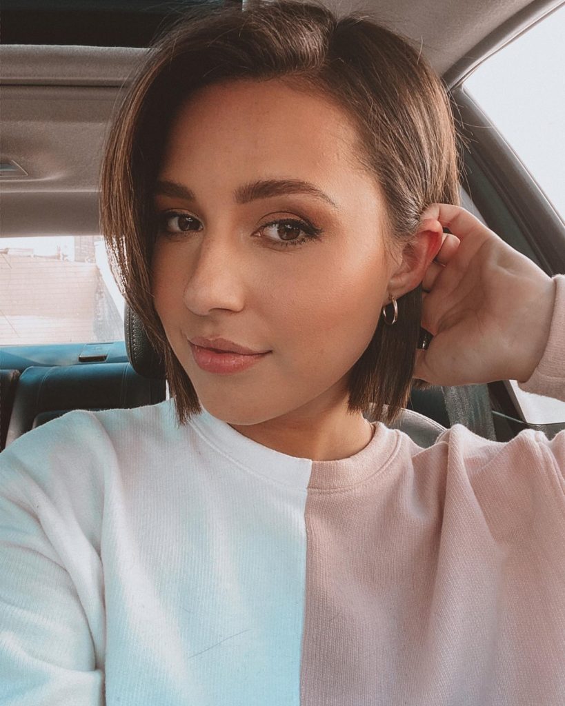 A woman with short brown hair smiling