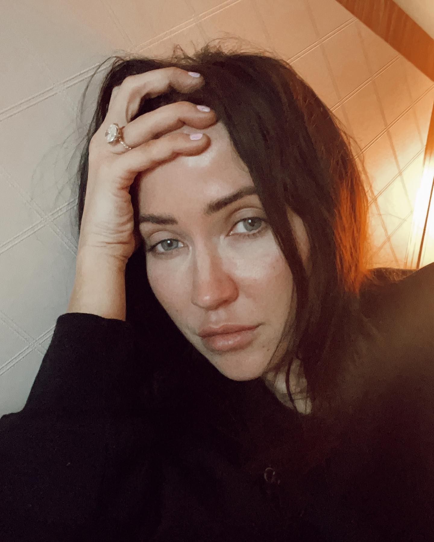 A woman with her hand on her forehead