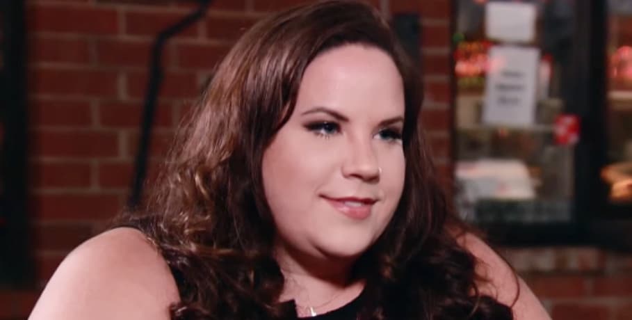 A woman with shoulder-length brown hair smiling