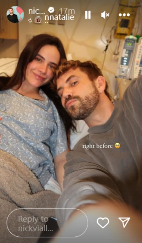 A pregnant woman and a man sitting next to each other. 