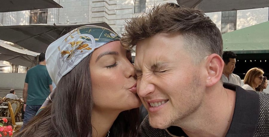 A woman kissing a man on the cheek