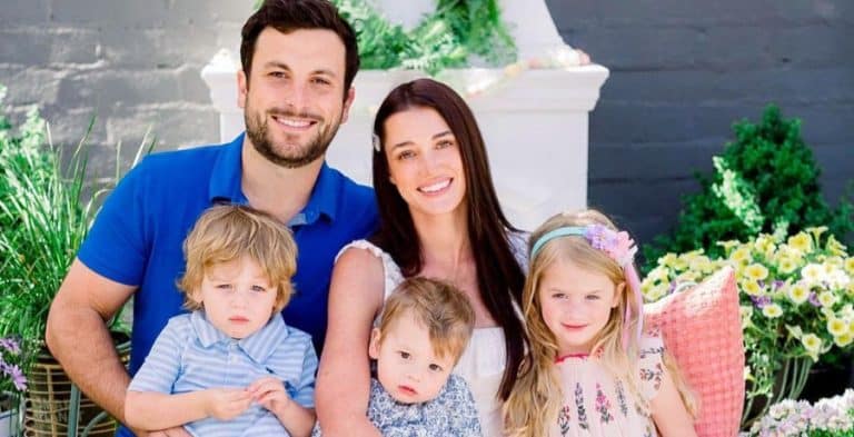 A man and a woman with their three kids