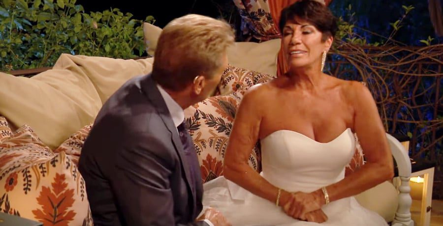 A man in a grey suit and a woman in a white dress.