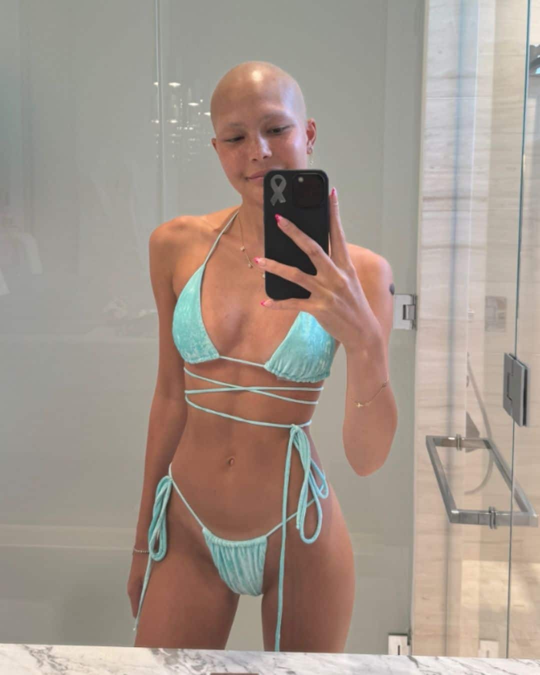 Isabella Strahan posing for mirror selfie in blue bikini