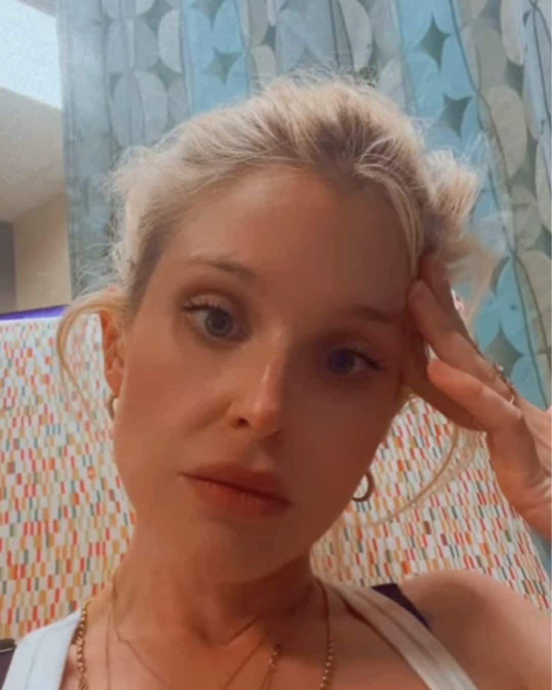 Kelly Osbourne looking stressed at the bedside of Sid Wilson in hospital